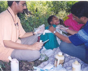 Speciality Camp-Ear, Nose & Throat Surgeon treating child patient in field